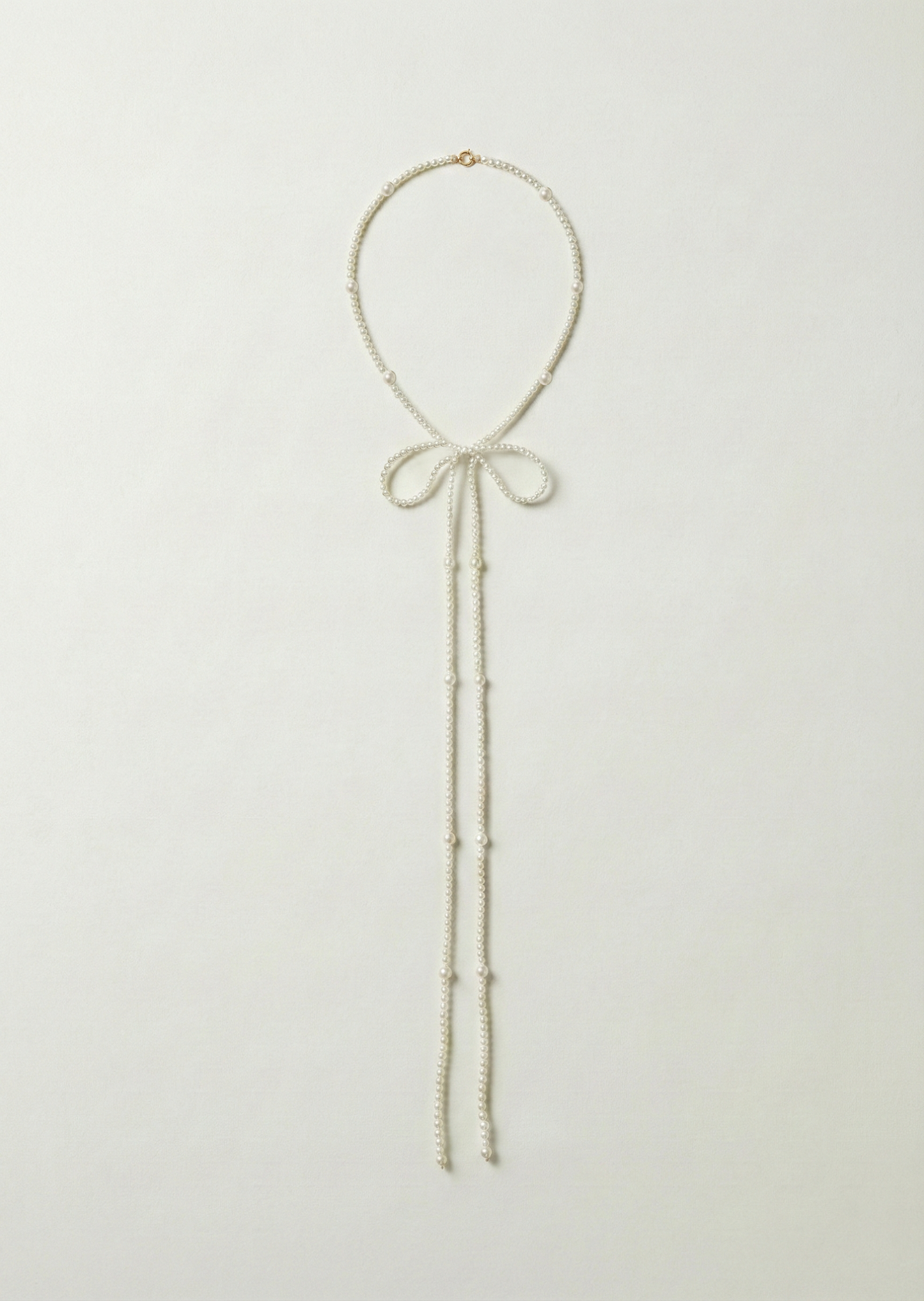 Long bow pearl necklace